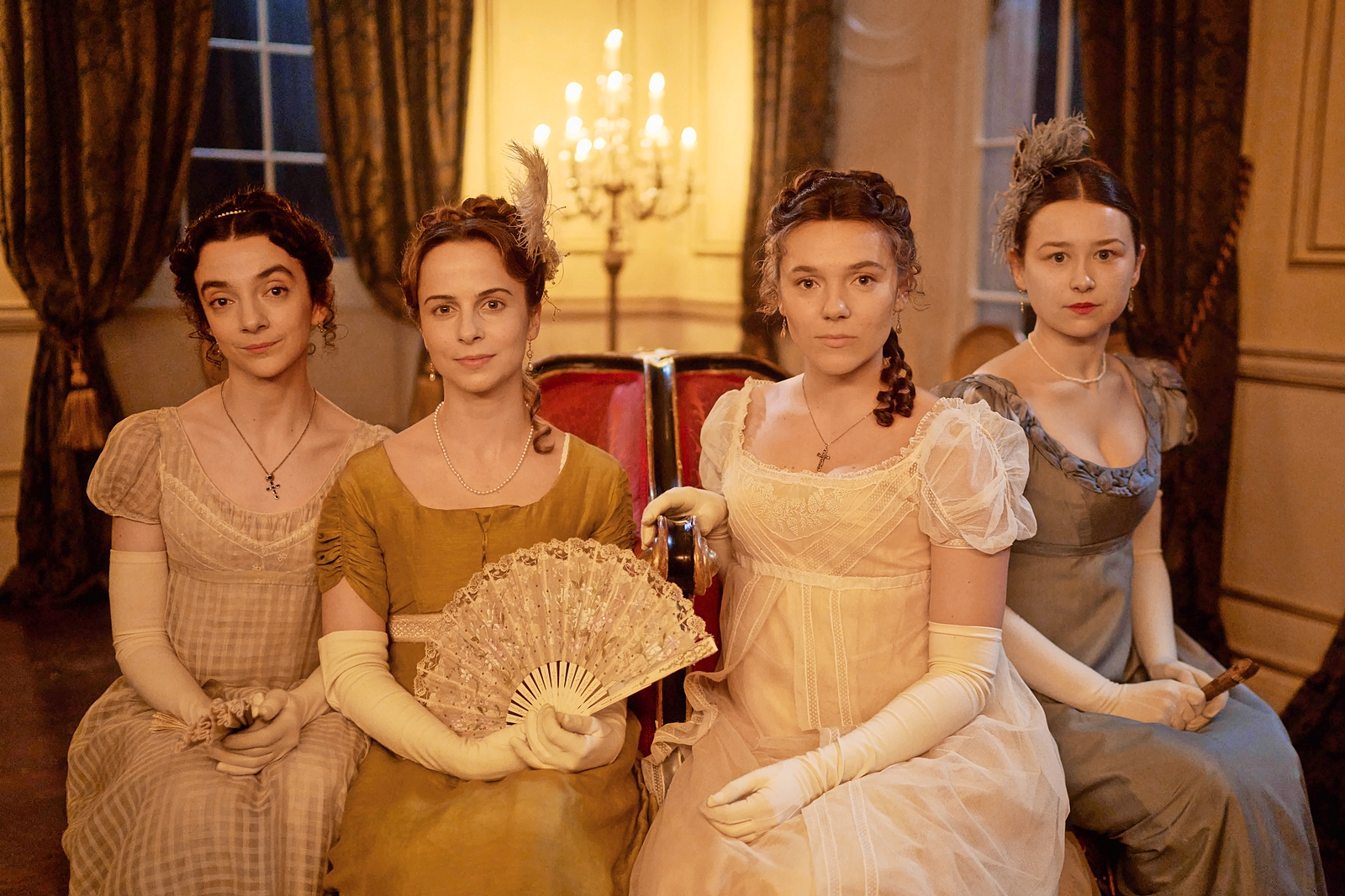Four women in Regency-era gowns.