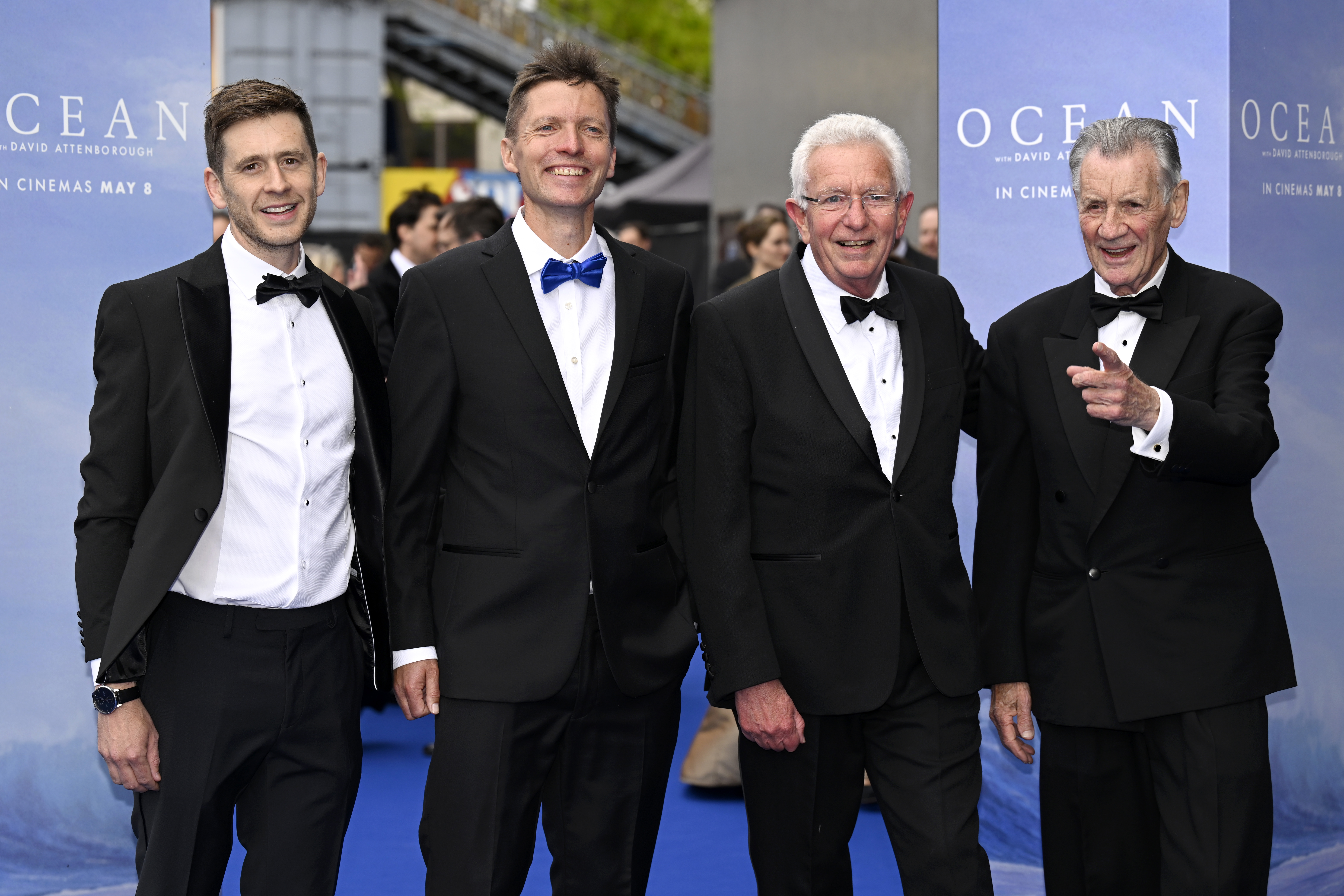 Four men in tuxedos with David Attenborough at the Ocean world premiere.